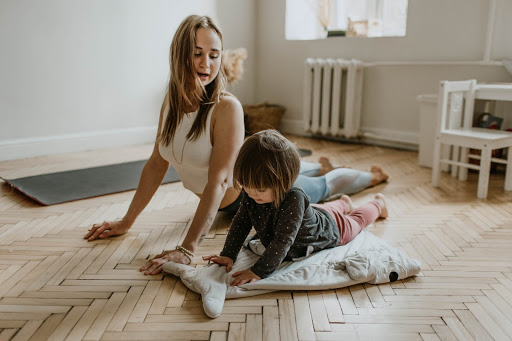 Mother and young child performing yoga together