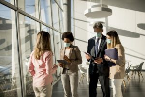 Group of multiethnic business people have a meeting and working in the office while wear mask as protection from corona virus