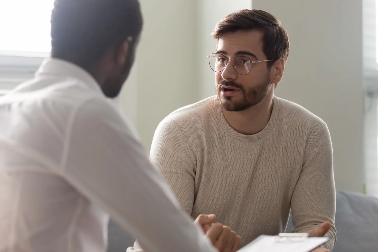 iStock-1252926473 A young adult male sitting down with his EAP counselor