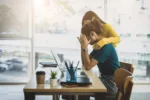 Coworker comforting stressed and discouraged woman in office.