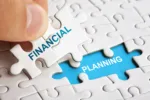 Hand holding piece of puzzle with words Financial Planning. Business concept